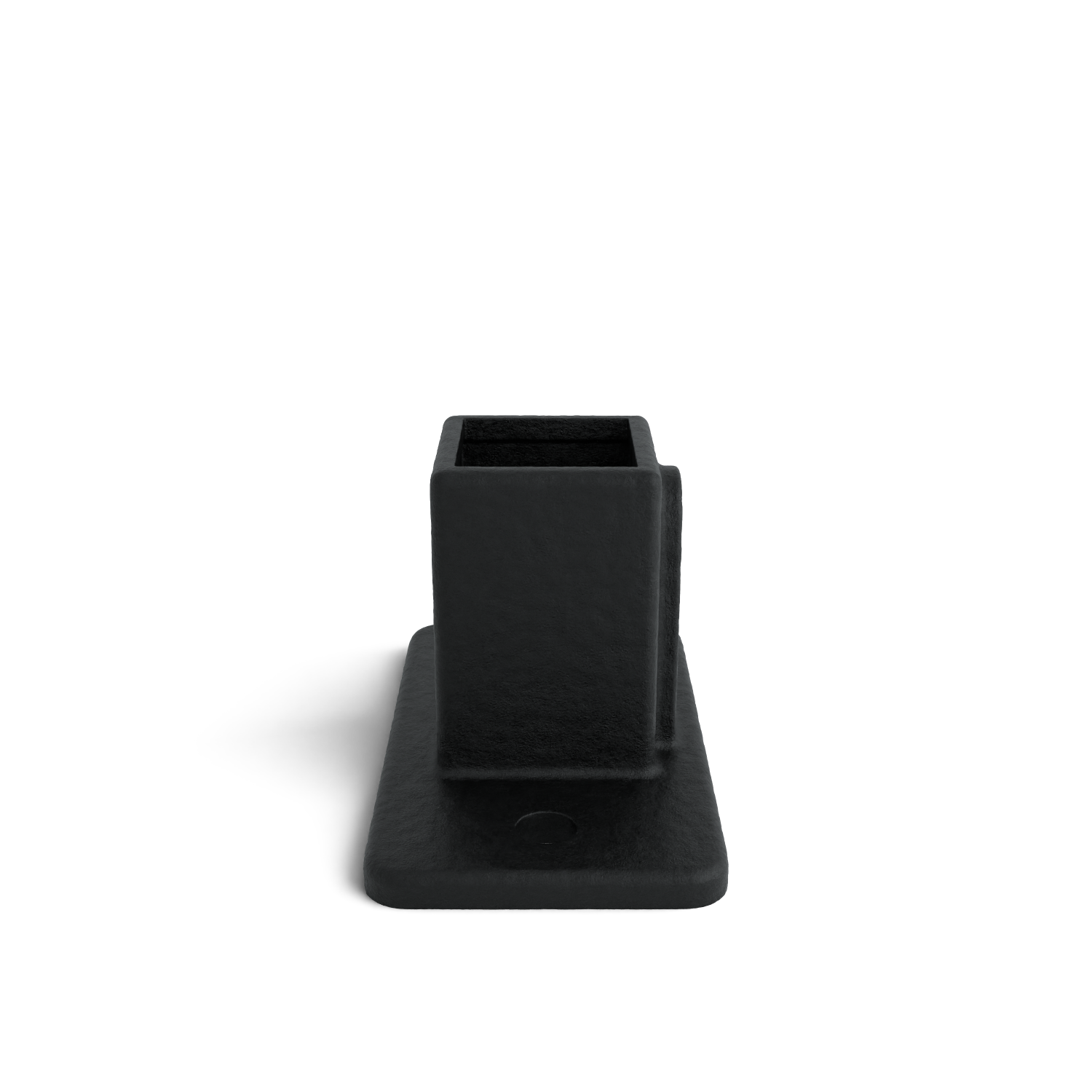 Objeto rectangular de color negro mate con una abertura cuadrada en la parte superior, sobre una base rectangular ancha y plana. Material ligeramente texturado. Situado en el centro sobre un fondo blanco, proyecta una ligera sombra hacia la derecha.